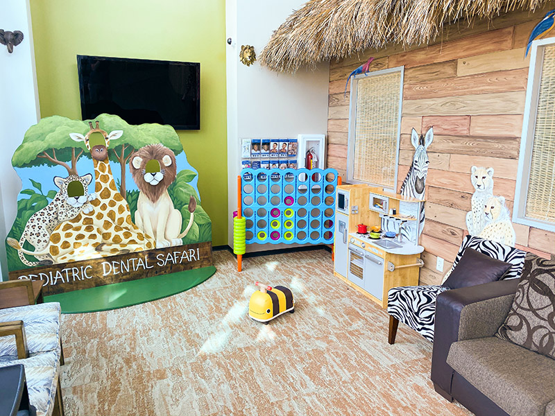 Children’s play area with animal artwork, games, and toys
